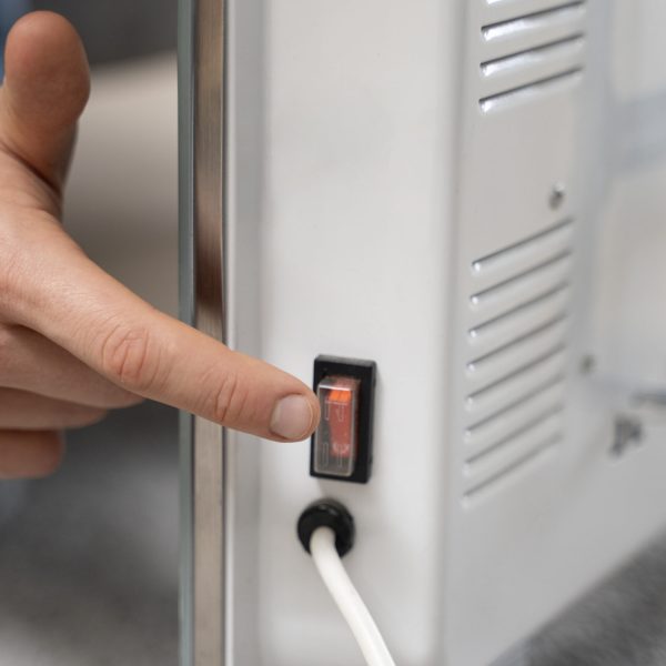 close-up-hand-pushing-heater-s-botton